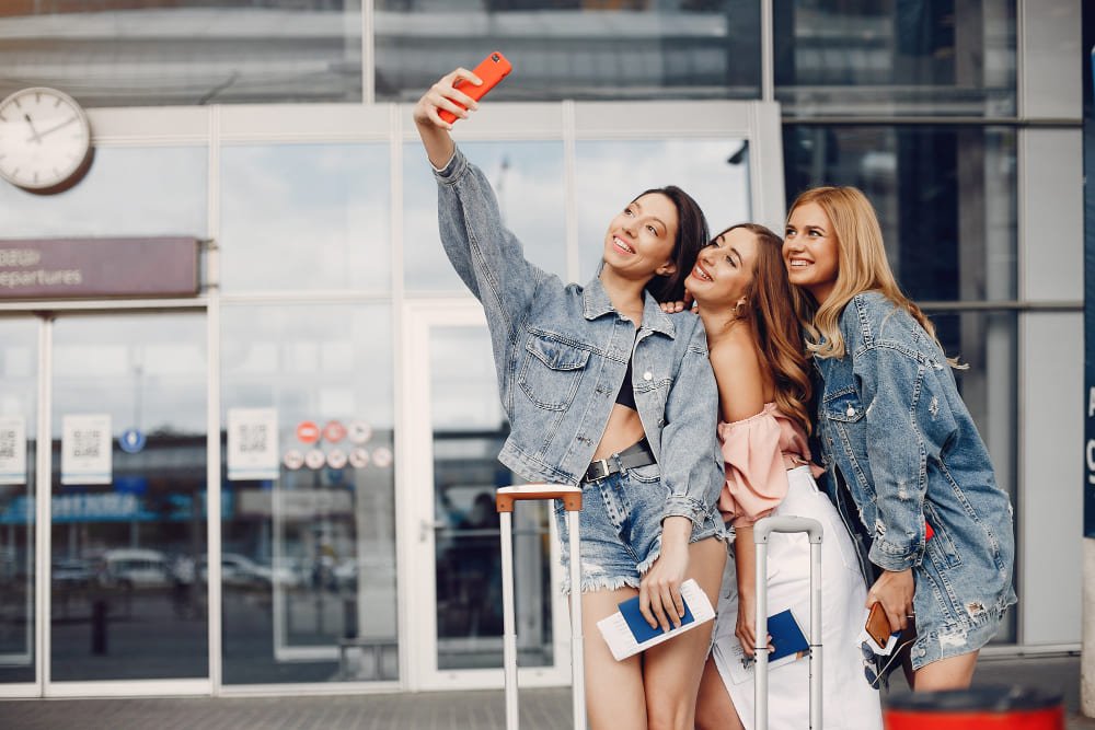 tres chicas guapas pie esperando a su transfer desde el aeropuerto de Ibiza